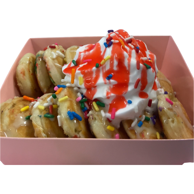 Classy Scoops mini pancakes in a pink box with whipped cream, rainbow sprinkles and strawberry drizzle